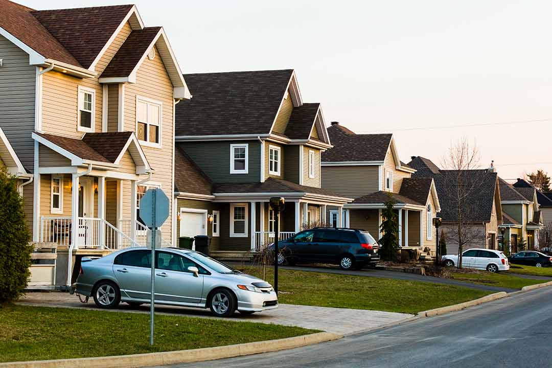 view of a family friendly neighborhood with cars parked in the driveway